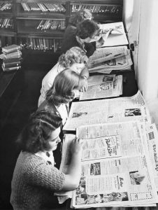 Women reading the newspaper at Museums Victoria.